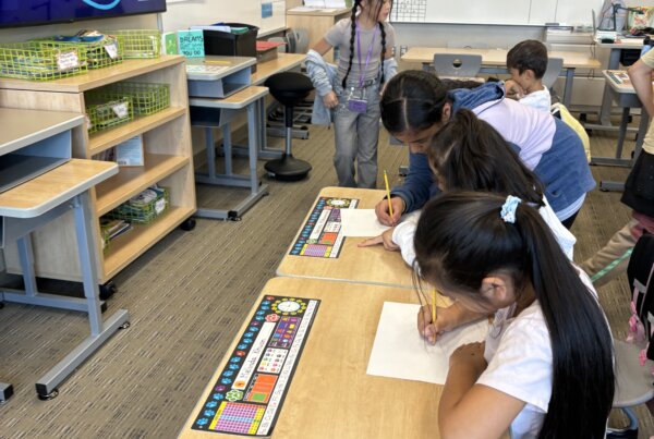 Character ambassadors helping peers complete a worksheet on the Attitude of Gratitude
