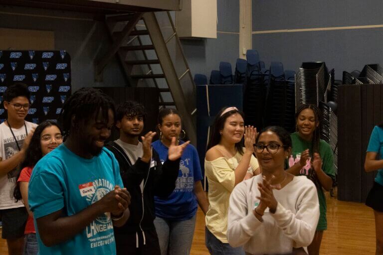 Student Mentors clapping and smiling, getting to know mentees.